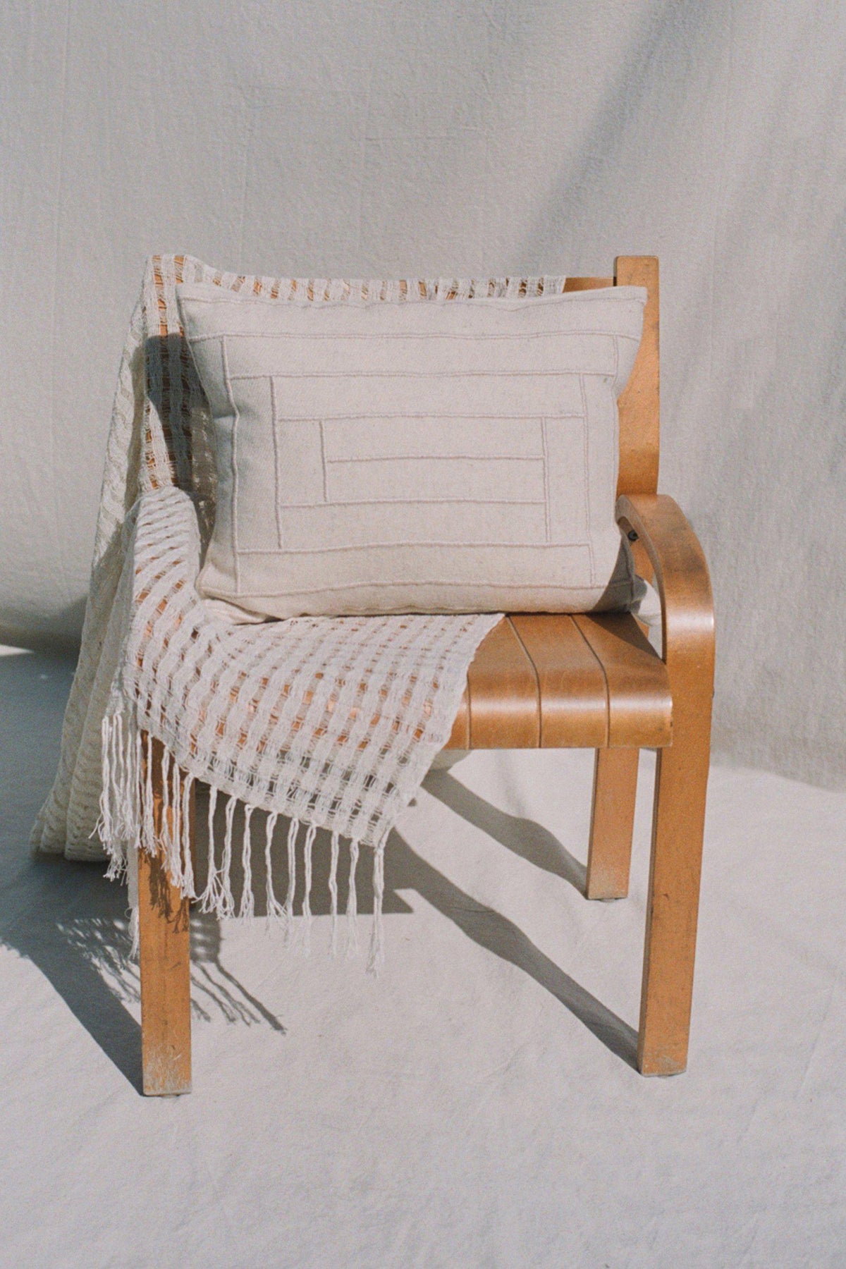 Cream Embroidered Pillow and Cream Wabi Sabi Blanket by Mexchic | H. SMITH